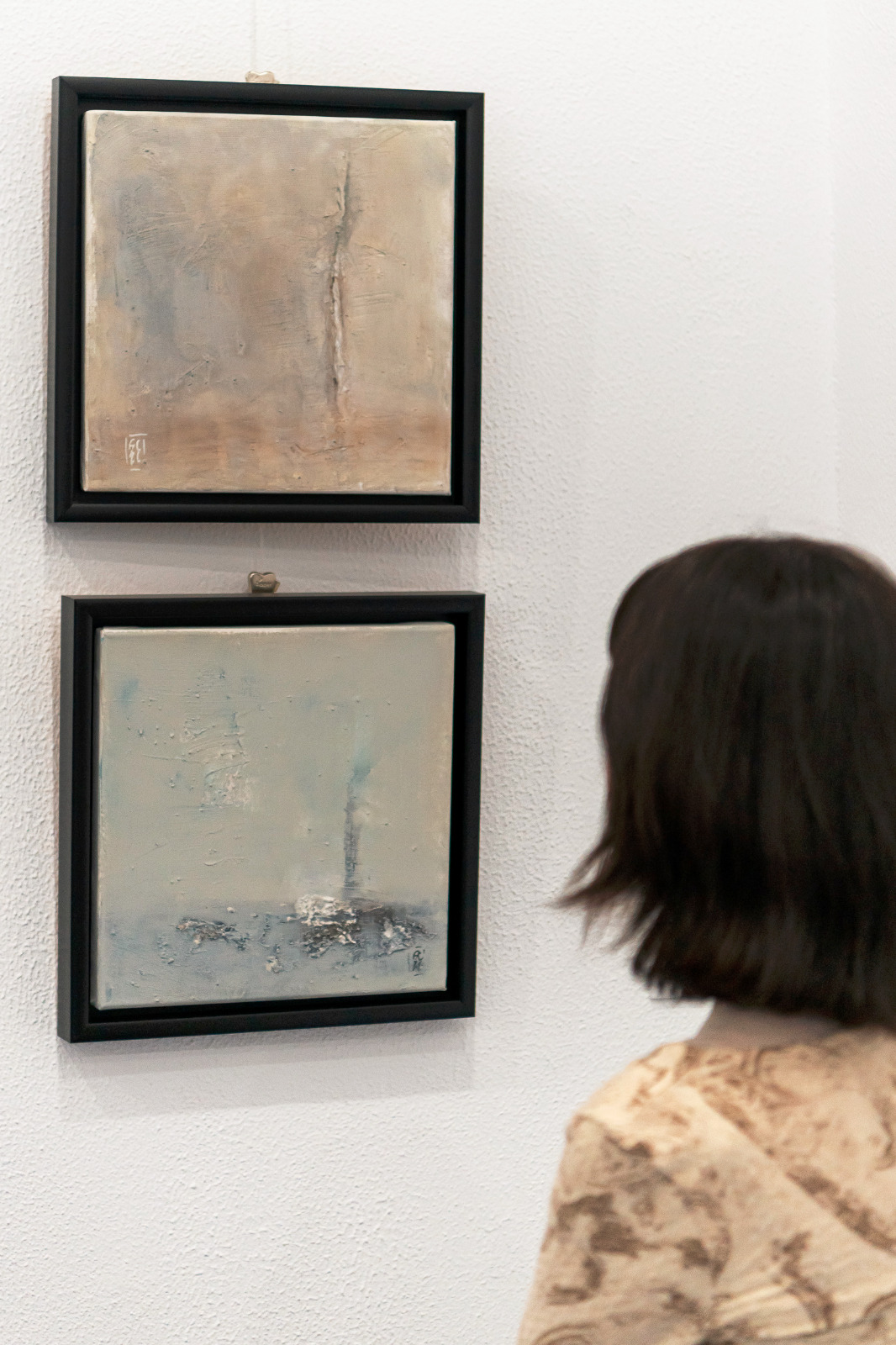 A visitor looking at the works in the Sedimental exhibition